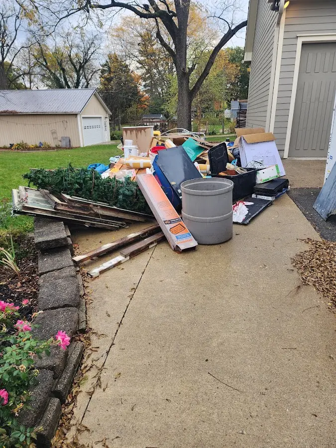 Dumpster being loaded with debris for Roofing Dumpster Rental in Eldridge